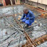 Electrical Engineer installing conduit pipes for wiring on decking in lekki